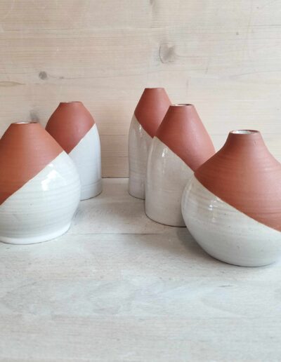 Photograph of 6 two-tone white and terracotta bottles